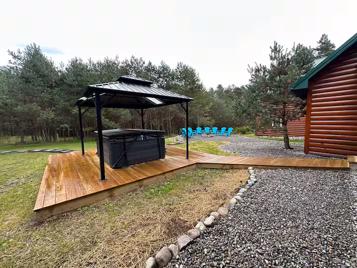 Outdoor hot tub under a gazebo on the deck, shared by cabin and loft guests when booked together