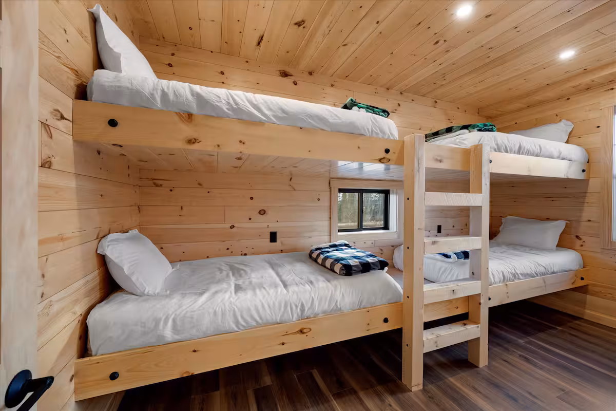 Built-in pine bunk room with two sets of twin bunk beds